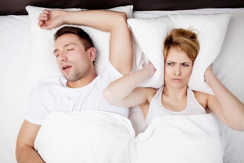 Snoring man and young woman. Couple sleeping in bed-img-blog