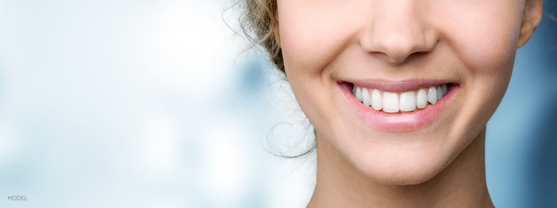 Close up image of smiling woman with white teeth.