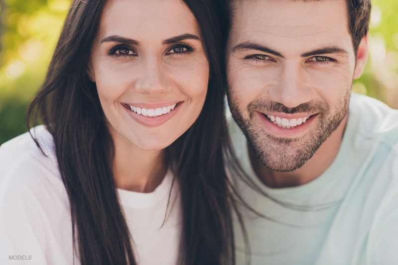 Young couple smiling together.