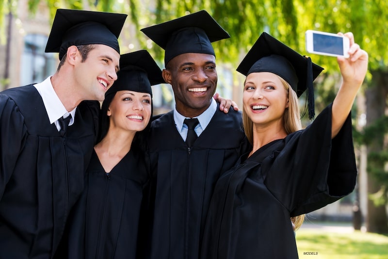 Graduating students taking a selfie.